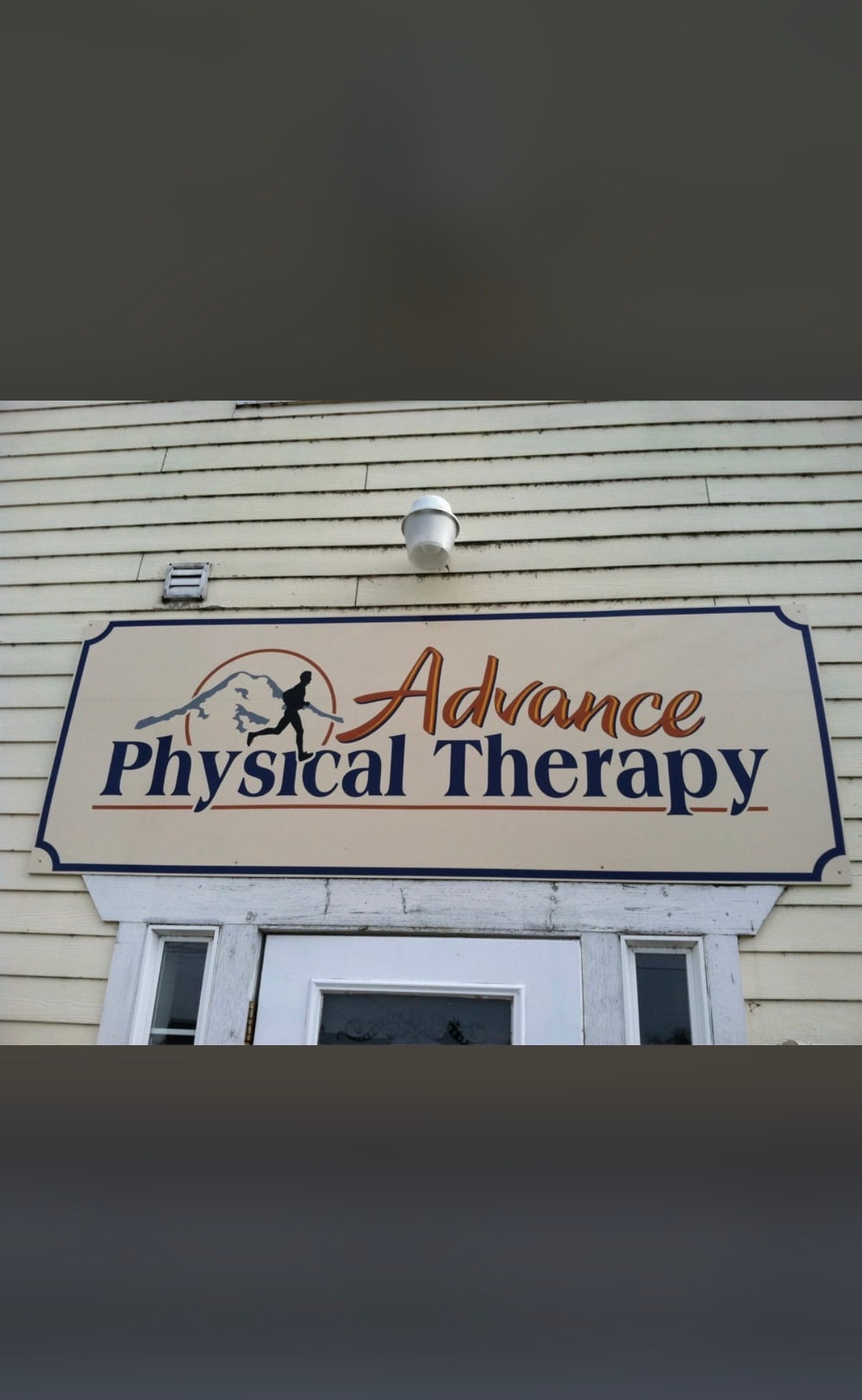 Physical therapist guiding a patient through a gentle mobility exercise at Advance Physical Therapy in Orting, WA